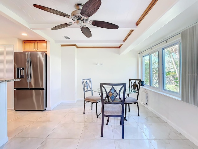 tiled dining space with ceiling fan