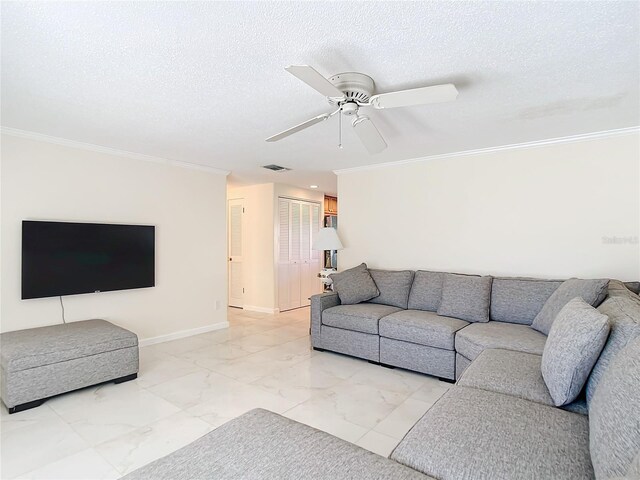 living room with ceiling fan, crown molding, and a textured ceiling