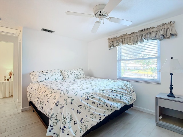 bedroom with ceiling fan and light hardwood / wood-style flooring