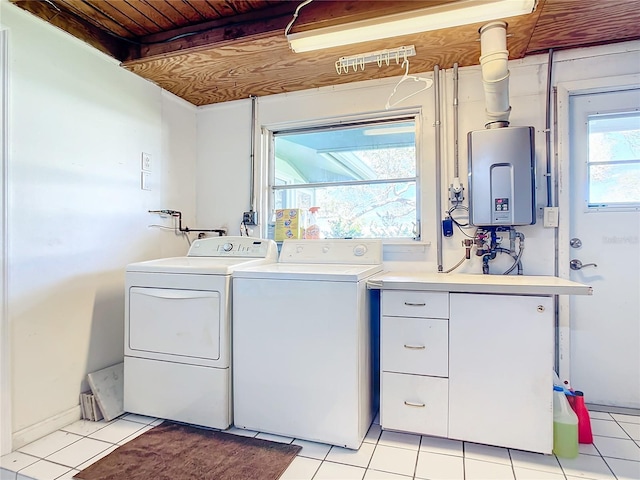 laundry area featuring water heater, independent washer and dryer, and light tile patterned floors