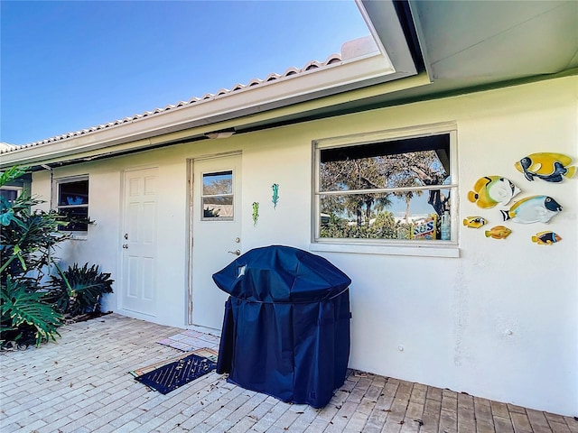 property entrance featuring a patio area