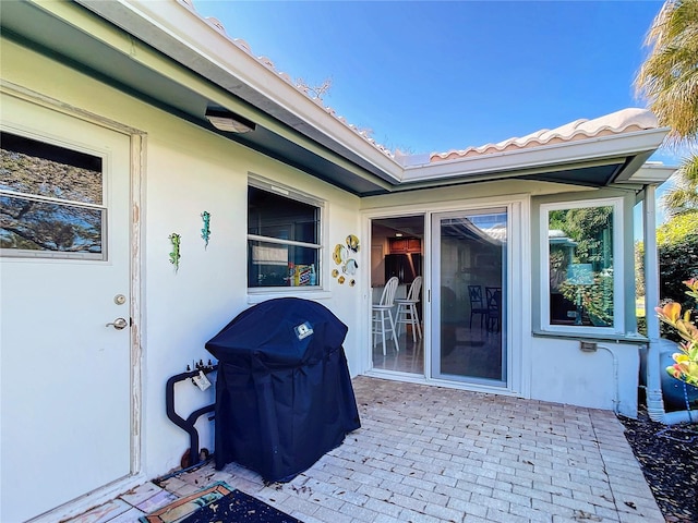 view of exterior entry featuring a patio area