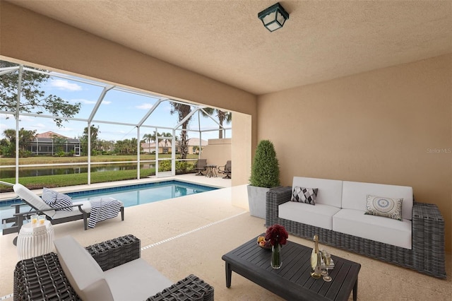 pool featuring a patio, glass enclosure, and an outdoor living space