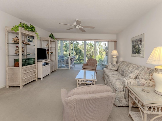 carpeted living room with ceiling fan