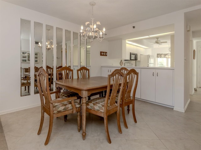 tiled dining space featuring a chandelier