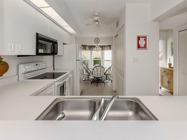 kitchen featuring sink, white appliances, ceiling fan, white cabinetry, and hanging light fixtures