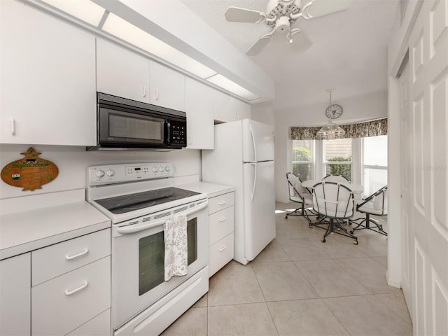 kitchen with light tile patterned flooring, white cabinetry, hanging light fixtures, ceiling fan, and white appliances