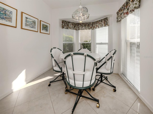 tiled dining area with an inviting chandelier