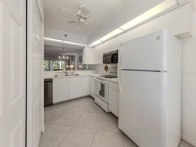 kitchen featuring ceiling fan with notable chandelier, sink, white cabinets, light tile patterned floors, and white appliances