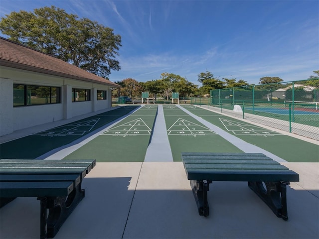 surrounding community with tennis court