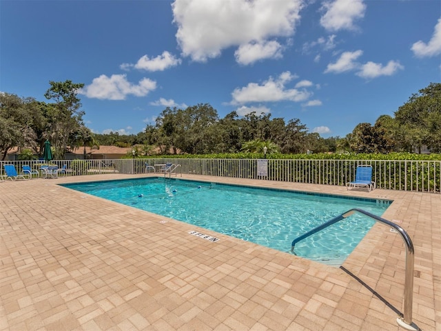 view of swimming pool with a patio area