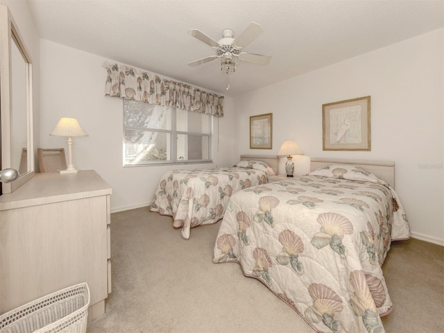 carpeted bedroom with ceiling fan and a closet