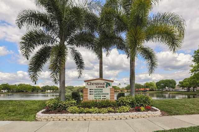 community / neighborhood sign with a water view