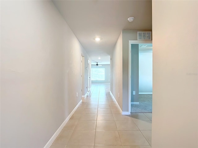 hall with light tile patterned floors