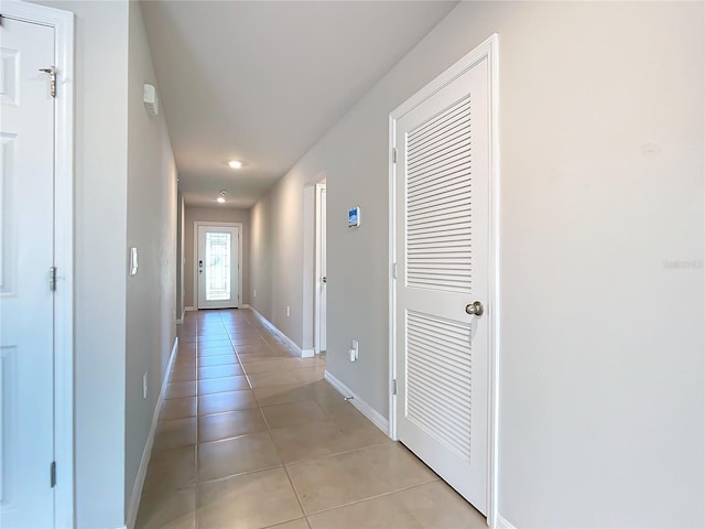 corridor featuring light tile patterned floors