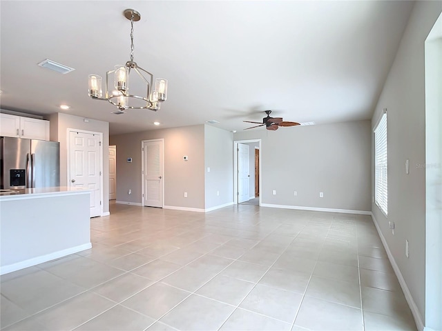 unfurnished living room featuring ceiling fan with notable chandelier and light tile patterned floors