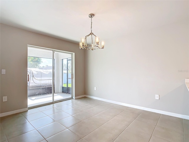 empty room featuring an inviting chandelier and light tile patterned floors