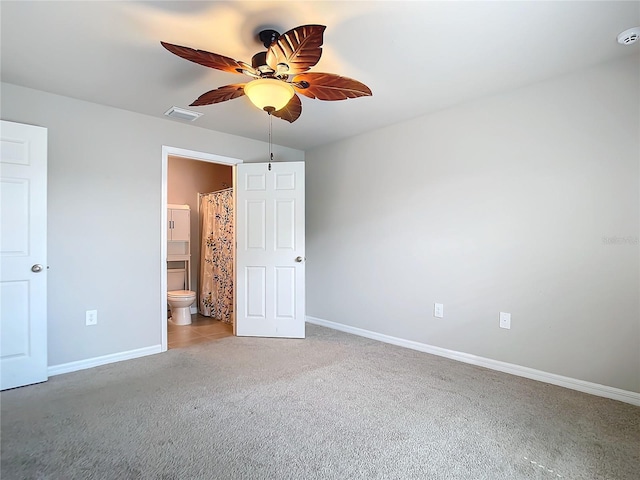 unfurnished bedroom with light carpet, connected bathroom, and ceiling fan