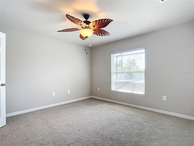 carpeted empty room featuring ceiling fan