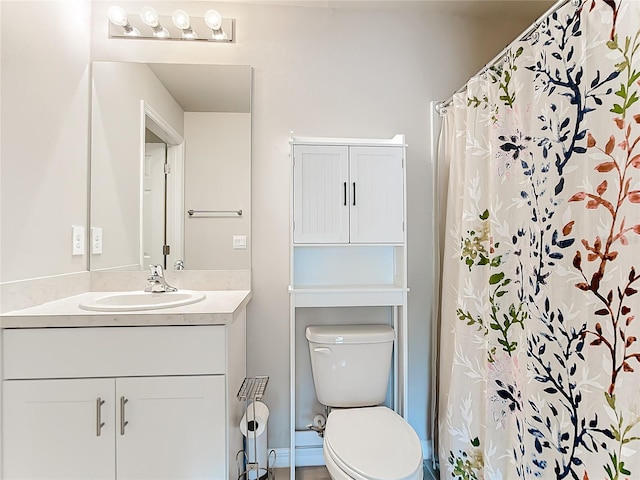 bathroom with toilet, vanity, and a shower with curtain