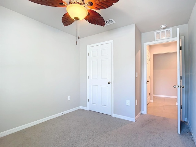 unfurnished bedroom with ceiling fan and light carpet