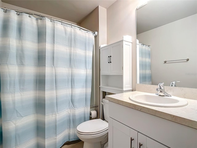 bathroom featuring toilet and vanity