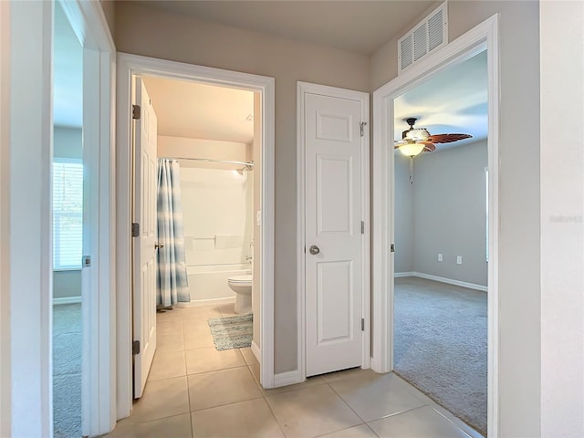 hall featuring light tile patterned floors