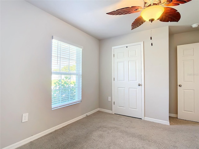 unfurnished bedroom featuring ceiling fan and light colored carpet