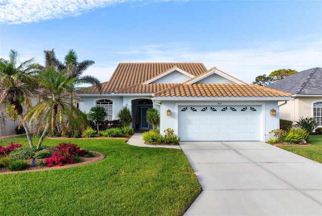 mediterranean / spanish house with a garage and a front lawn