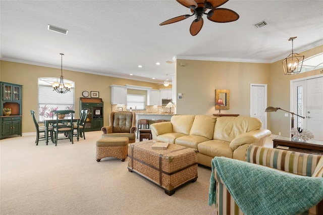 carpeted living room with crown molding and a healthy amount of sunlight