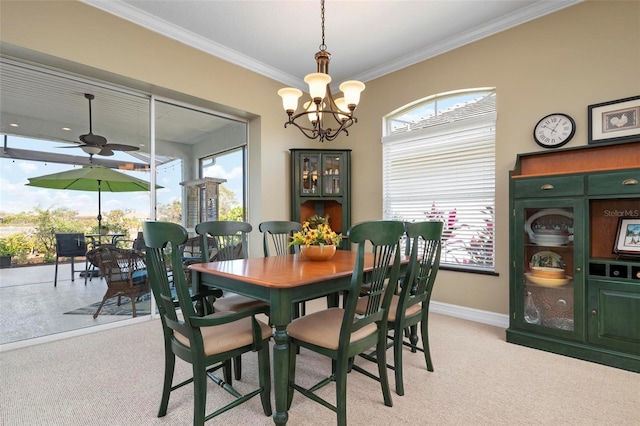 dining area featuring crown molding, ceiling fan with notable chandelier, and light carpet