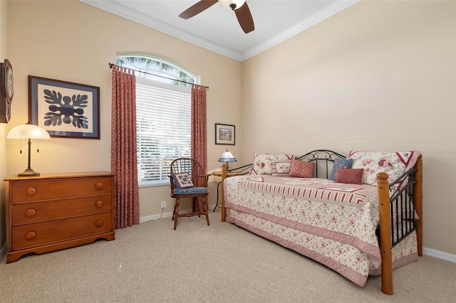 carpeted bedroom with ceiling fan and ornamental molding