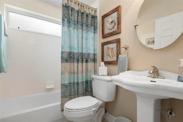 full bathroom with shower / bath combo, sink, and toilet