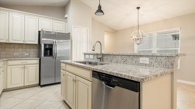 kitchen with appliances with stainless steel finishes, decorative backsplash, decorative light fixtures, vaulted ceiling, and sink