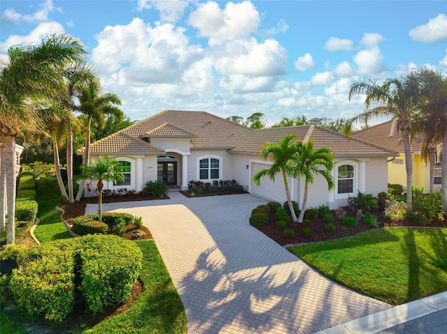 mediterranean / spanish-style home with a garage