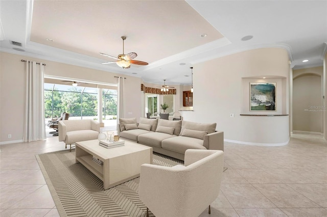 living area featuring light tile patterned floors, visible vents, a raised ceiling, and baseboards