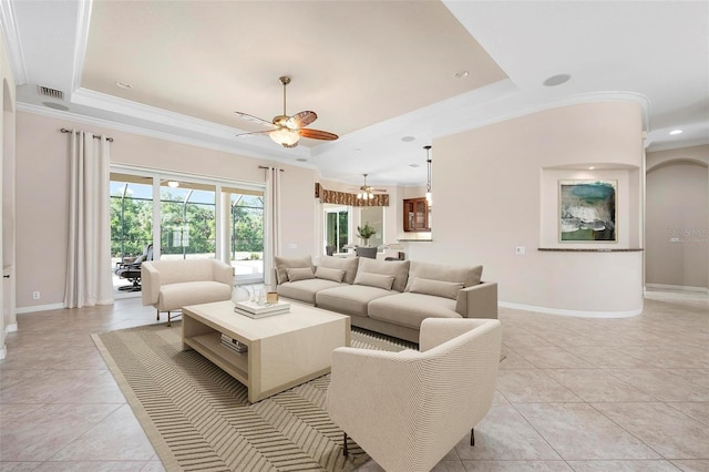 living area with ceiling fan, baseboards, visible vents, light tile patterned flooring, and a tray ceiling
