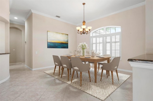 dining space with visible vents, crown molding, a chandelier, and baseboards
