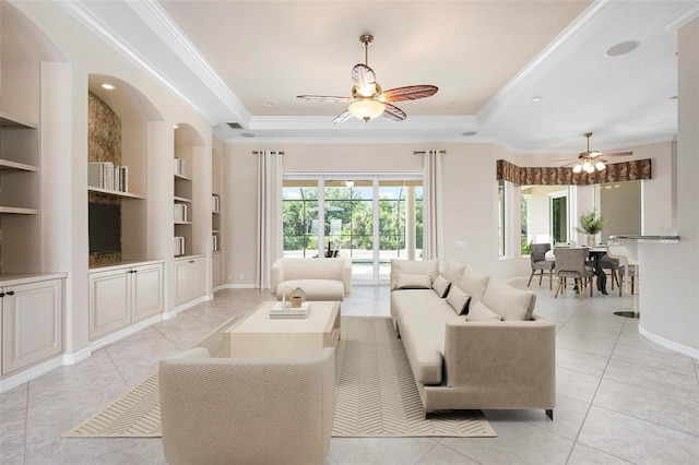 living area with light tile patterned flooring, a ceiling fan, built in features, and baseboards