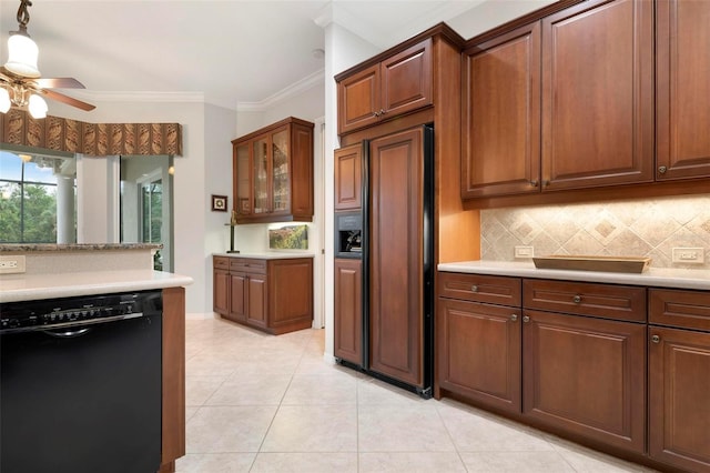 kitchen featuring paneled refrigerator, light tile patterned floors, black dishwasher, light countertops, and backsplash