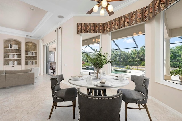 dining area featuring a sunroom, built in shelves, light tile patterned flooring, ceiling fan, and ornamental molding