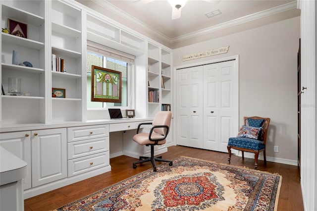 office with dark wood-type flooring, crown molding, a ceiling fan, and built in study area