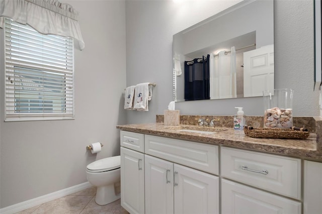 full bathroom with baseboards, walk in shower, toilet, tile patterned floors, and vanity