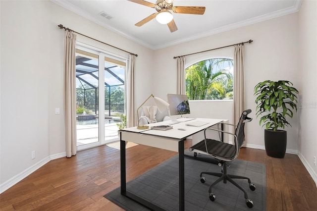 home office with crown molding, ceiling fan, visible vents, hardwood / wood-style floors, and baseboards