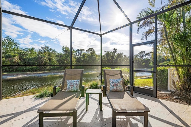 sunroom / solarium with a water view and a wealth of natural light