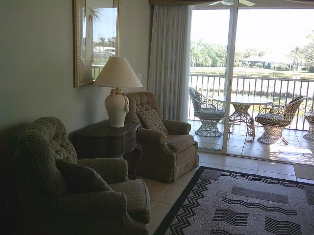 living area with ceiling fan and light tile patterned floors