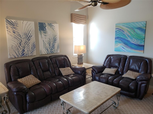 carpeted living area with a ceiling fan