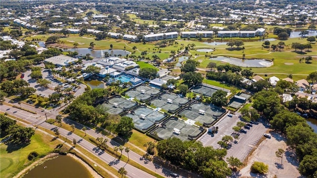 drone / aerial view with a residential view, a water view, and golf course view