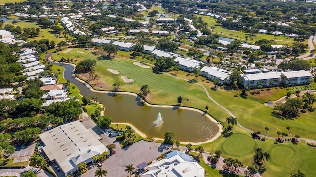 drone / aerial view featuring golf course view and a water view