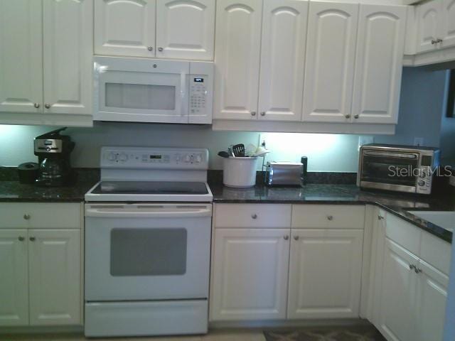 kitchen with white appliances and white cabinets